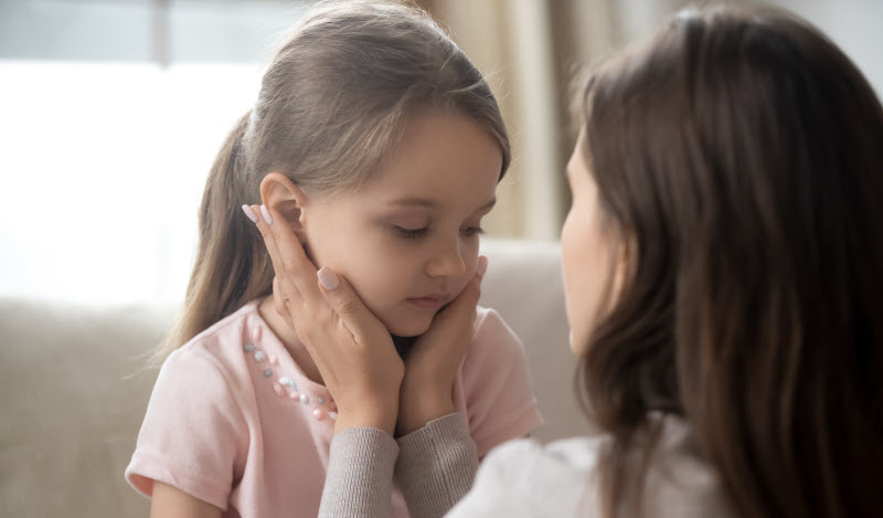 Cairns Paediatric Psychology - Bereaved child need Loving young mother touching upset little daughter face,