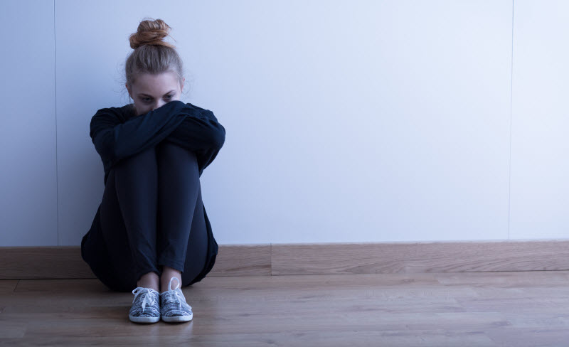 Cairns Paediatric Psychology - Childhood developmental phases understanding death Sad teenager sitting on the floor