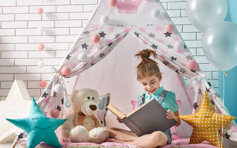 Cairns Paediatric Psychology - Feeling good activities Happy girl reading inside here text at home