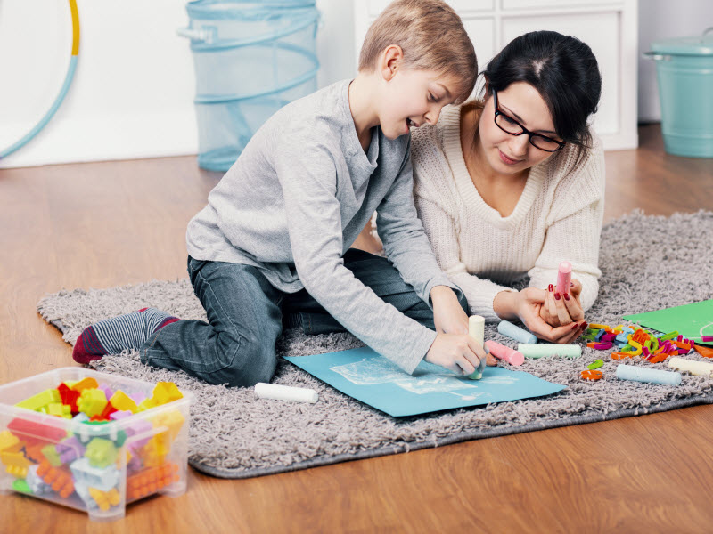 Cairns Paediatric Psychology - Learning strategies for ADHD patient Mother and daughter drawing in a paper while lying on the floor