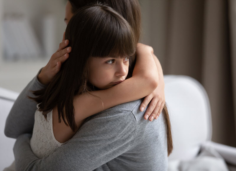 Cairns Paediatric Psychology - Separation anxiety Symptoms and signs upset little daughter cuddling mother,