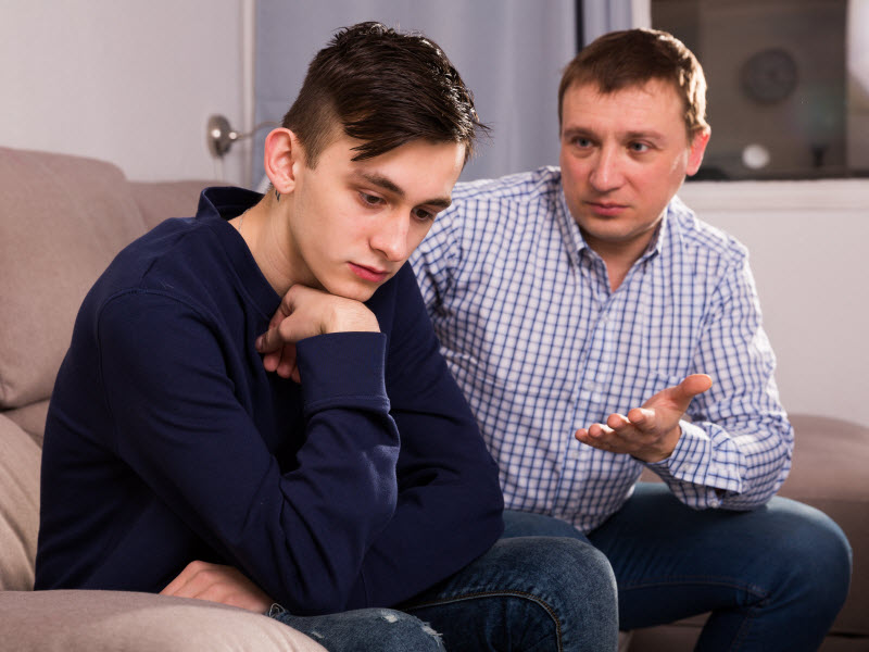 Cairns Paediatric Psychology - Swap negative thoughts Father seriously talking to his son on the couch