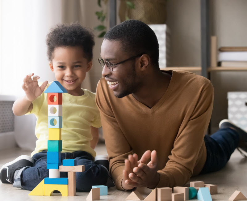 Cairns Paediatric Psychology - Teach problem solving strategies Happy cute little son playing multicolored tower with father