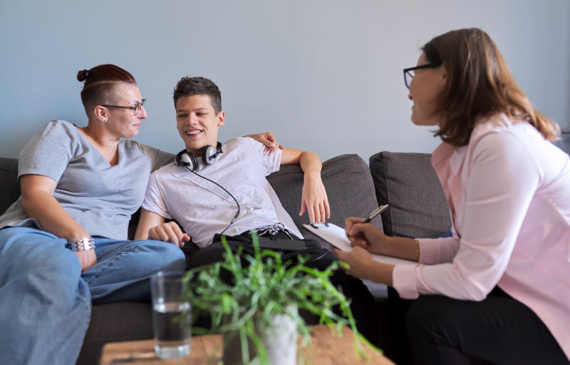 Cairns Paediatric Psychology - Treatment process with family support Mother with her teenage son at meeting with social worker or psychologist